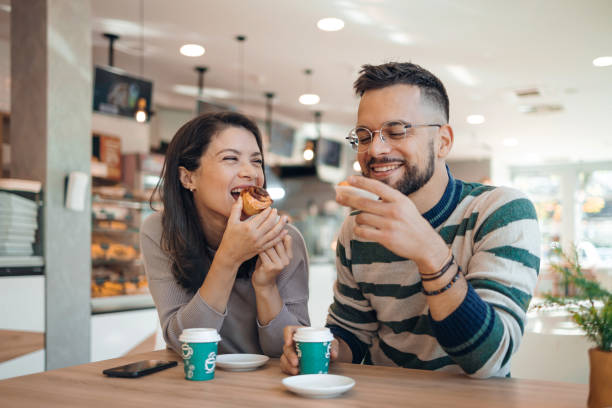 istock Couple enjoys sweet pastries in bakery 1992038827
