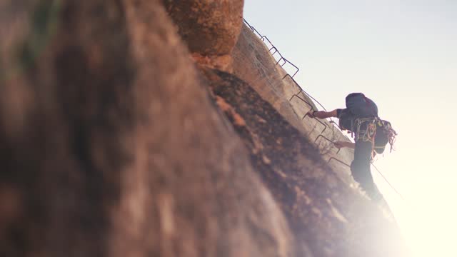 Woman climb mountain by via ferrata