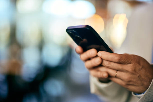 istock Close-up of a female hands holding and using a mobile phone. 1992043510