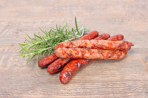 sausages and merguez grill in wooden background
