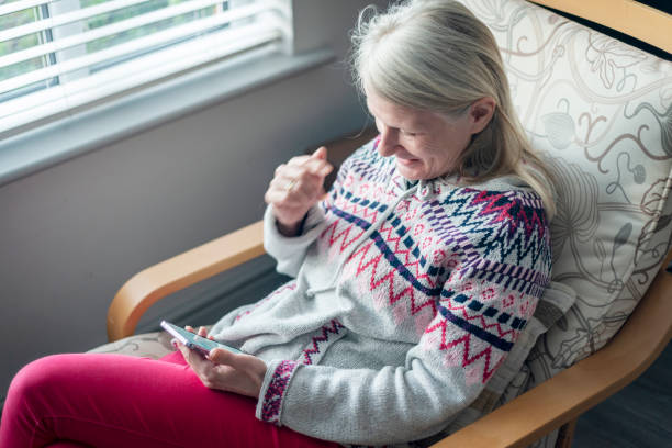 istock A middle aged woman,using her smartphone,at home,checking up on friends,Worcestershire,England,UK. 1992044550