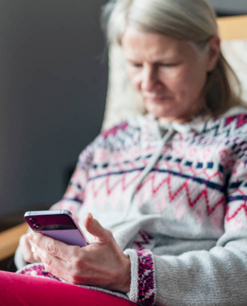 istock A middle aged woman,using her smartphone,at home,checking up on friends,Worcestershire,England,UK. 1992044551