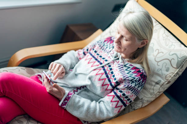 istock A middle aged woman,using her smartphone,at home,checking up on friends,Worcestershire,England,UK. 1992045056