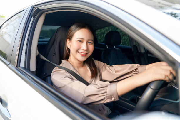 istock Woman smiling while driving her car 1992050827