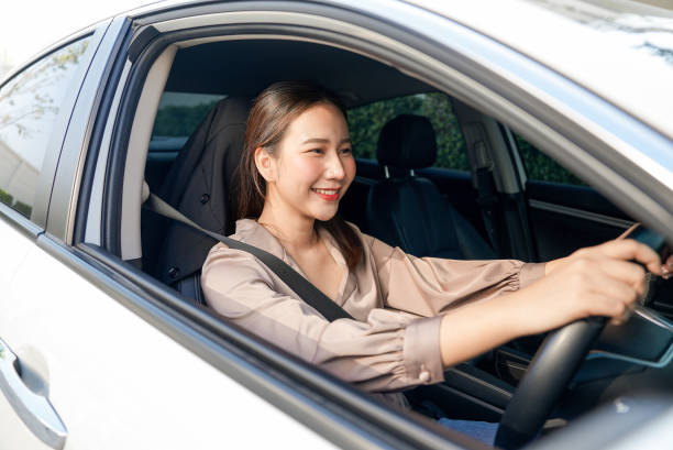 istock cheerful woman enjoying new car 1992050828