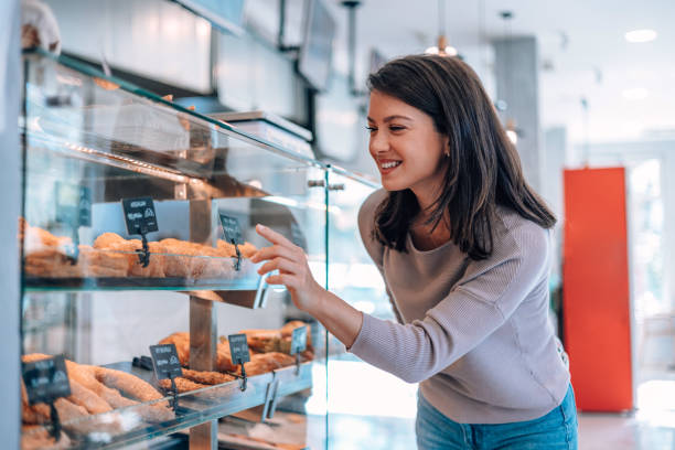 istock Woman selecting delicious pastries at the bakery 1992051370