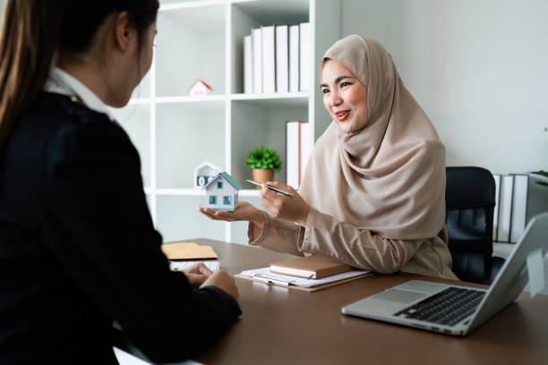 istock Real Estate Agent and client talking about Property insurance and security concept about house to client before sign contract 1992064041