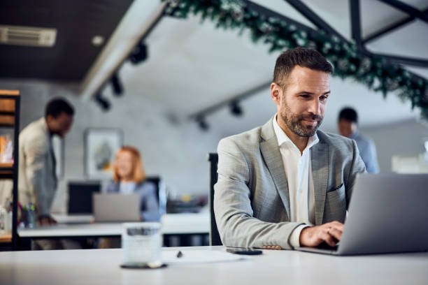 istock Focus on the businessman sitting and working online, at the co-working space. 1992064050