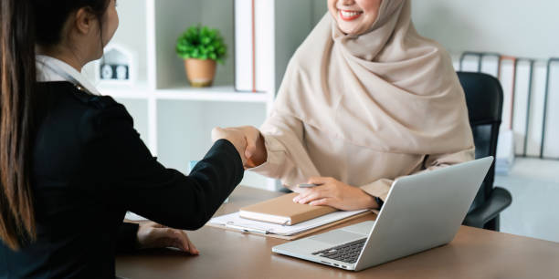 istock Real estate broker agent manager shaking hands with a client after successful agreement in the office 1992064591
