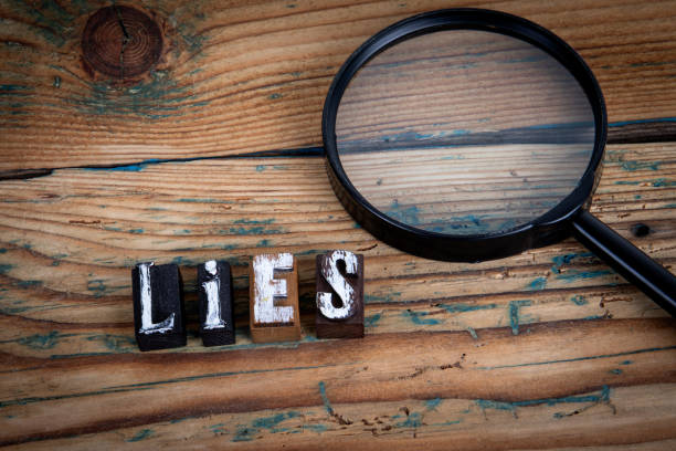 istock LIES. Alphabet letters on wood texture background 1992069412