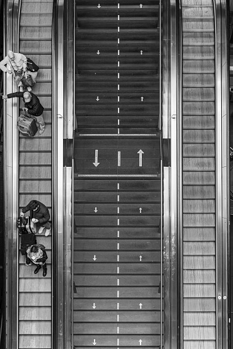 Germany, Berlin, December 31, 2023 - High angle view of people on escalator at railroad station, Berlin Moabit