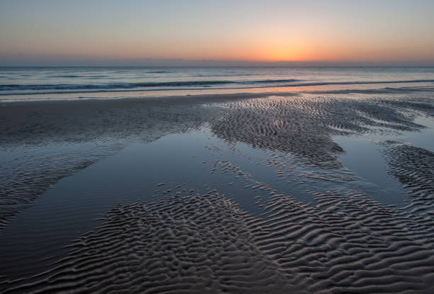 Sunrise with low clouds on Omaha Beach Normandy France in summer