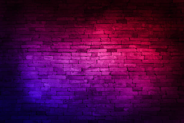 istock Neon light on brick walls that are not plastered background and texture. Lighting effect red and blue neon background of empty brick basement wall. 1992098482