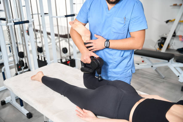 istock Specialist massages a patients body with a special massager 1992123446