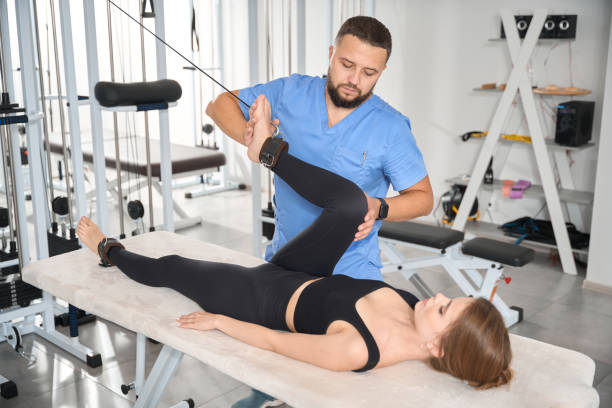 istock Experienced kinesiologist uses a special simulator to work with patient 1992123522