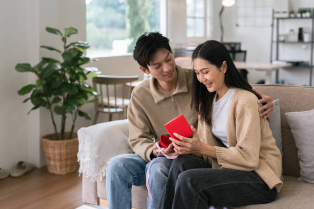 istock Young couple celebrating and giving present on Valentine's Day. Romantic day together. Valentine's Day concept 1992126741