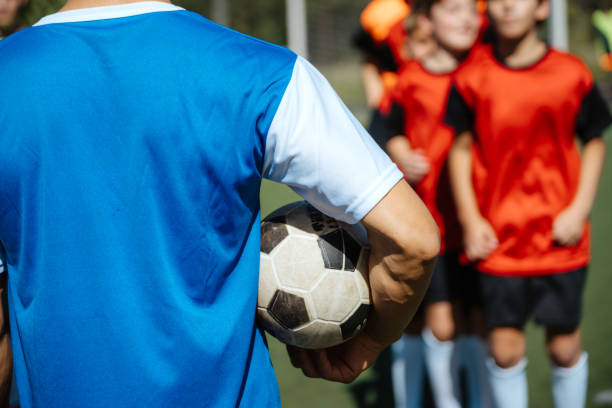 istock Young Soccer Team Ready for Game, Player Holding Ball 1992135672