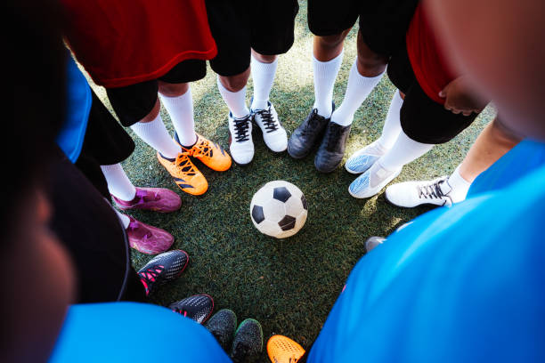 istock Young Soccer Team United Around Ball on Field Before Game 1992140975