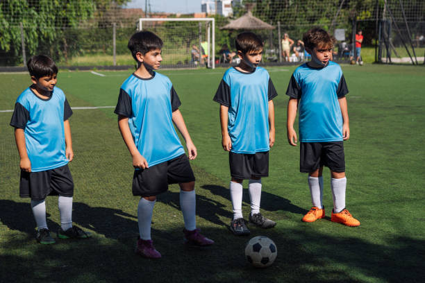 istock Young Soccer Players Standing on Field in Team Uniforms 1992143101
