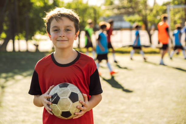 istock Happy young boy with soccer ball 1992150522