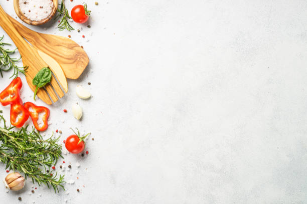 istock Food background with spices, herbs and utensil on white background. 1992153696