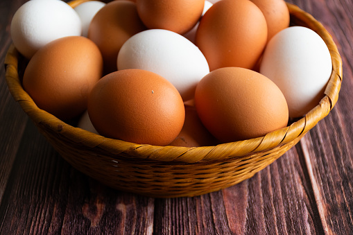 Fresh organic chicken eggs on a wooden rustic background