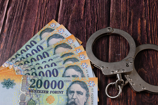 Hungarian 20000 ft banknotes and handcuffs