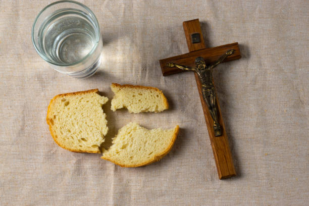 istock Lent - Bread, water and crucifix 1992160574