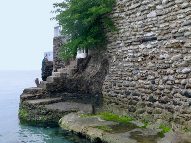istock A castle wall made of stone near the seashore. 1992163227