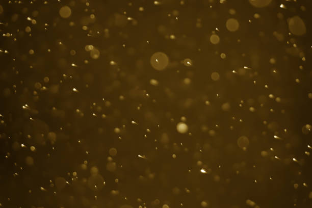 istock Abstract bokeh lights with gold background 1992174438