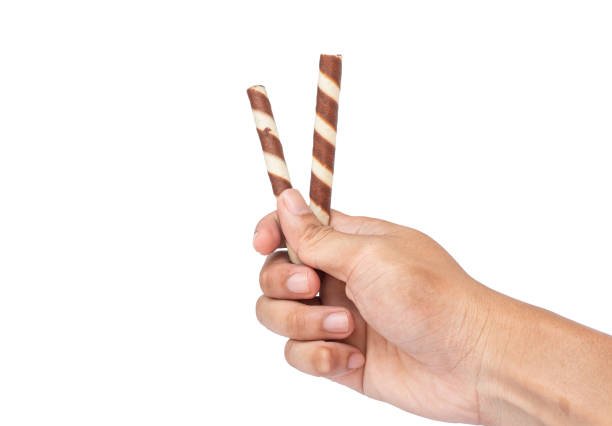Man's hand holding chocolate wafer bar isolated on white background. Clipping Path