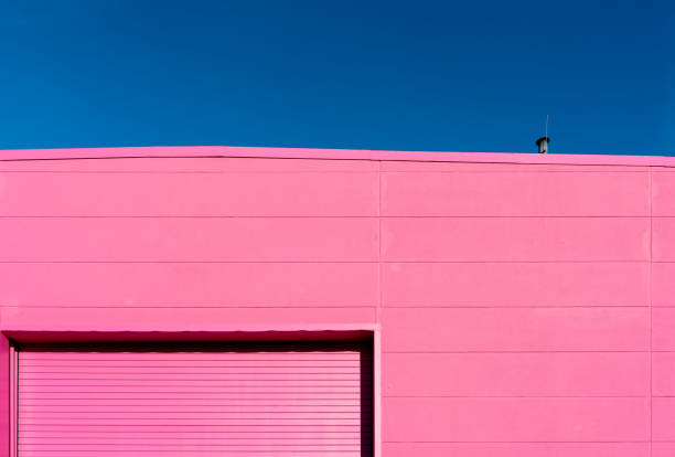 Pink corrugated metal wall creating a textured effect with diagonal lines