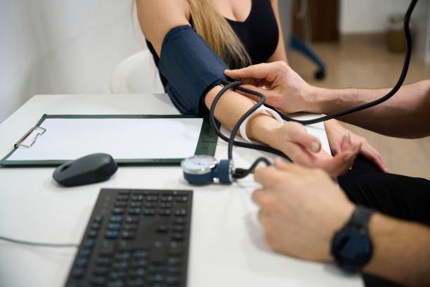 istock Doctor measures a patients blood pressure at a reception 1992195221
