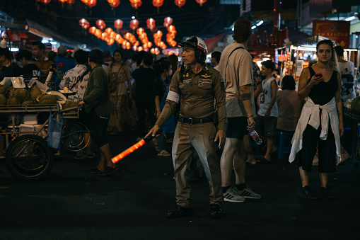 Phuket,Thailand-January 27,2024: Traffic Police doing his duty at Chinatown road