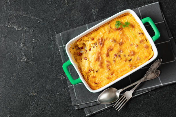 istock cheesy smoked sausage grits bake in ceramic dish 1992225133