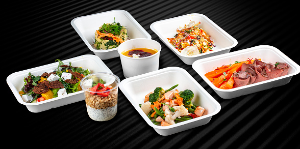 Colorful and nutritious meal kits prepared in eco-friendly containers for a convenient and healthy on-the-go meal.