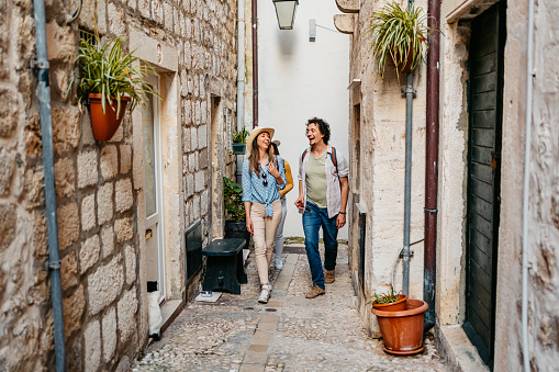 Young tourist couple walking in an alley in Dubrovnik in Croatia.