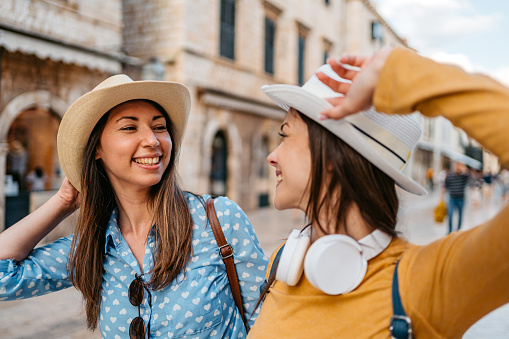 Two young female tourists walking on the street in Dubrovnik in Croatia.