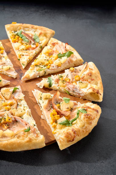 istock Hawaiian pizza with chicken, pineapple, and corn, a sweet and savory combination on a perfectly baked crust 1992246980