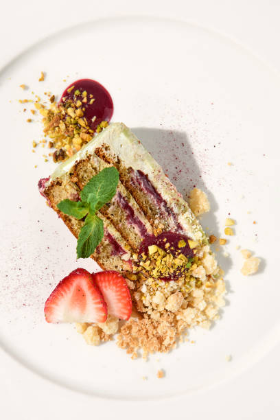 istock Pistachio cake with a raspberry layer and crumbled cookie-pistachio topping, isolated on a white background, top view 1992247578