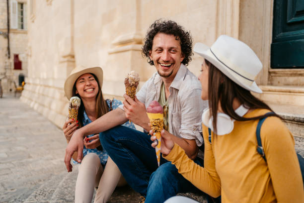 istock Three Young Friends Eating Ice Cream While Sitting On The Steps In Dubrovnik 1992256226