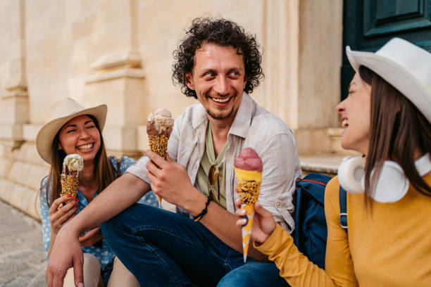 istock Three Young Friends Eating Ice Cream While Sitting On The Steps In Dubrovnik 1992256967