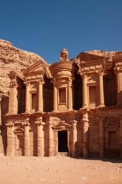 Jordan, Petra. Facade of Ad-Deir Monastery. Monastery, carved into sandy rocks, is one of most famous sights of Petra. Close-up. Facade of Ad-Deira resembles Treasury in a simplified version.