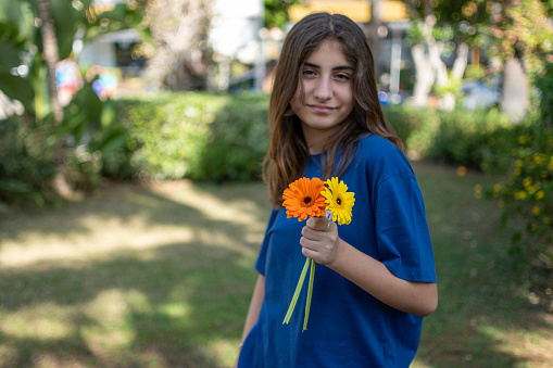 Several colourful gerberas as bouquet with teenage girl