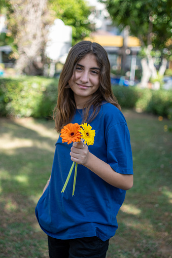 Several colourful gerberas as bouquet with teenage girl