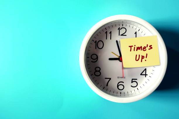 istock White clock on blue copy space background with note weitten TIME'S UP ,concept of time running out , time management to not miss a due date or a deadline 1992272346