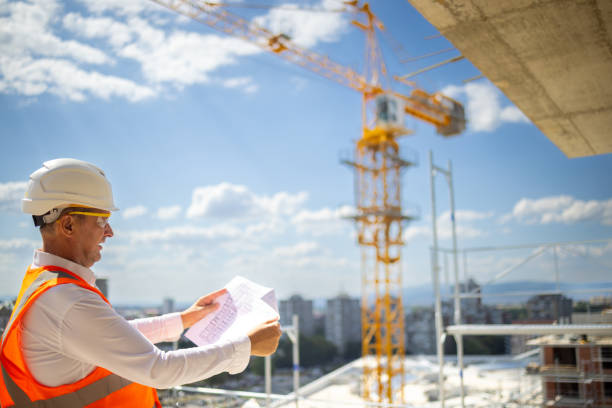 istock Caucasian engineer looking at the blueprint on the construction site 1992276338