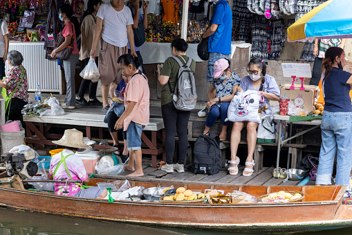 Local farmers and traders selling food and produce at a colourful floating market in Bangkok, Thailand’s vibrant capital city.