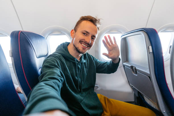 istock Young Man Taking Selfies In An Airplane 1992290349