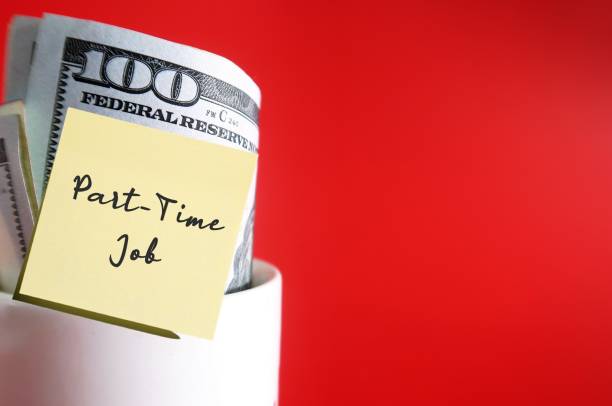 istock White ceramic cup with cash dollars money inside on red copy space background with note written PART-TIME JOB, financial goal to make extra earning or second income from side business or side hustle 1992293585